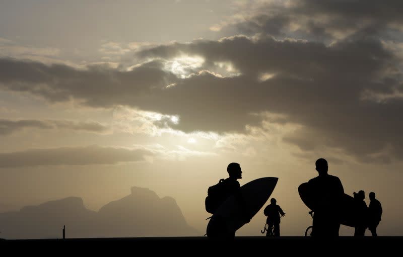 Surfers are seen at Recreio dos Bandeirantes beach, amid the coronavirus disease (COVID-19) outbreak, in Rio de Janeiro