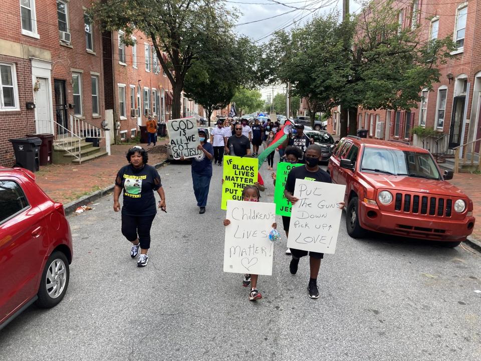 Pastor Margaret Guy of Stop the Violence Prayer Chain Foundation, left, leads an anti-violence march in Wilmington's West Center City on Sunday, Sept. 13, 2020