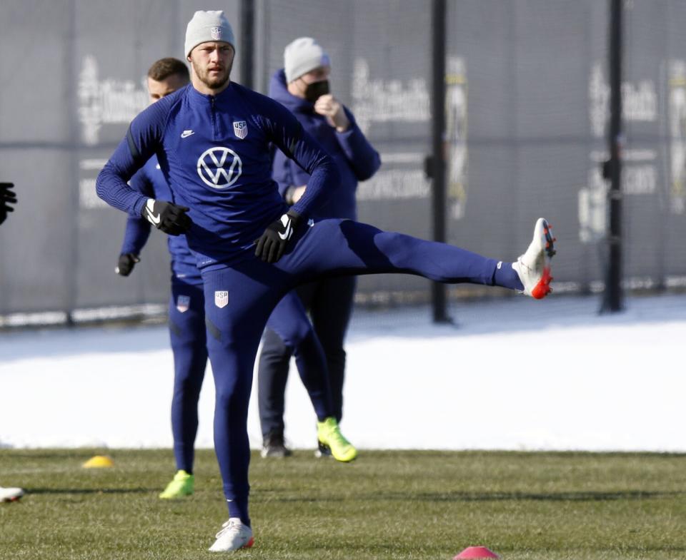 U.S. defender Walker Zimmerman lifts his lift leg to the side as he stretches during practice Wednesday in Columbus, Ohio.