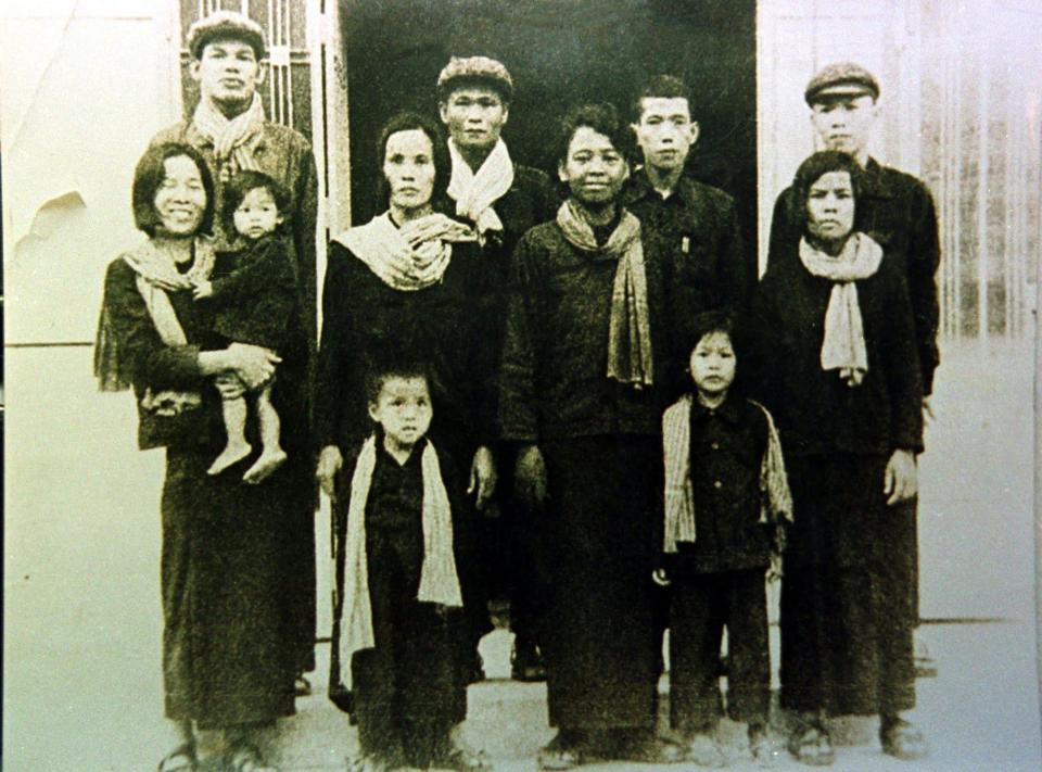 Comrade Duch, second from right in back row, with staff from Tuol Sleng in 1977 -  AP