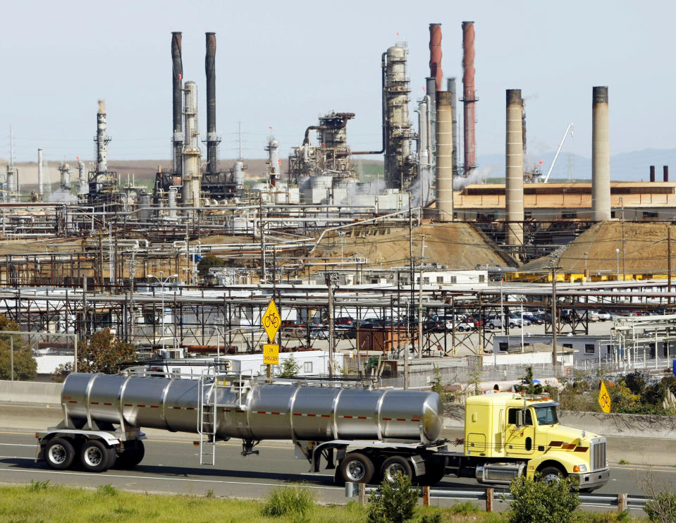 FILE - In this March 9, 2010, file photo a tanker truck passes the Chevron oil refinery in Richmond, Calif. A federal appeals court ruled Tuesday, May 26 against major oil companies in lawsuits brought by California cities and counties seeking damages for the impact of climate change. A panel of the 9th U.S. Circuit Court of Appeals said state courts are the proper forum for the lawsuits alleging that Big Oil promoted petroleum as environmentally responsible when producers knew it was causing damage. (AP Photo/Paul Sakuma, File)