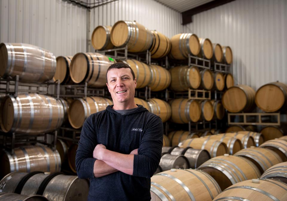 Ben Casteel, co-owner, director and winemaker at Bethel Heights Vineyard, works among barrels of aging wine on Oct. 11 at Bethel Heights in West Salem, Ore.