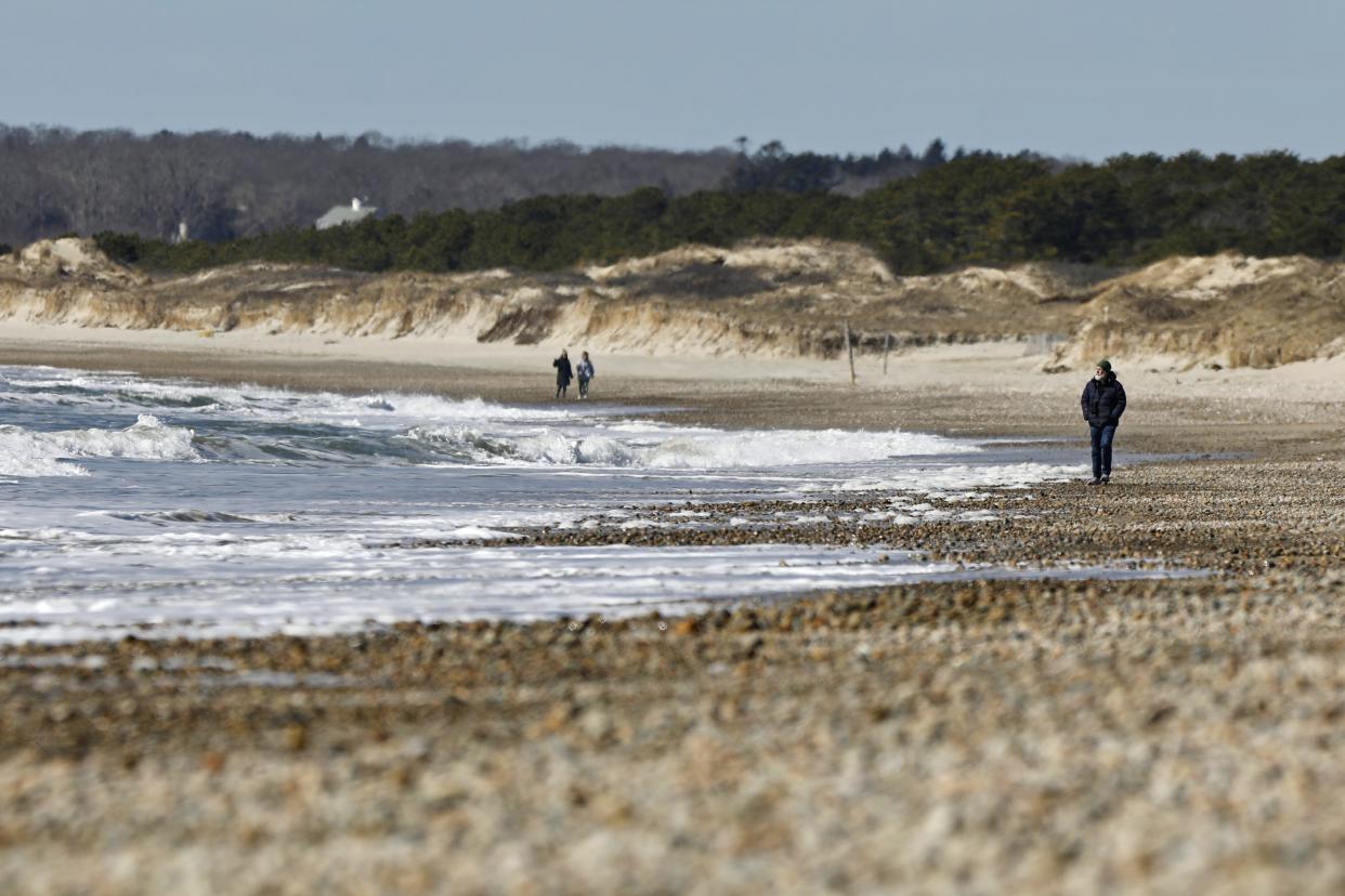 People take advantage of the great weather to go for a walk on the shore at Horseneck Beach in Westport.