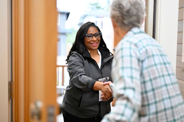 Democratic state Rep. Janelle Bynum talks with a voter in Oregon's 5th Congressional District in March. National Democrats see her as the best contender to flip a seat that is critical to retaking the U.S. House.