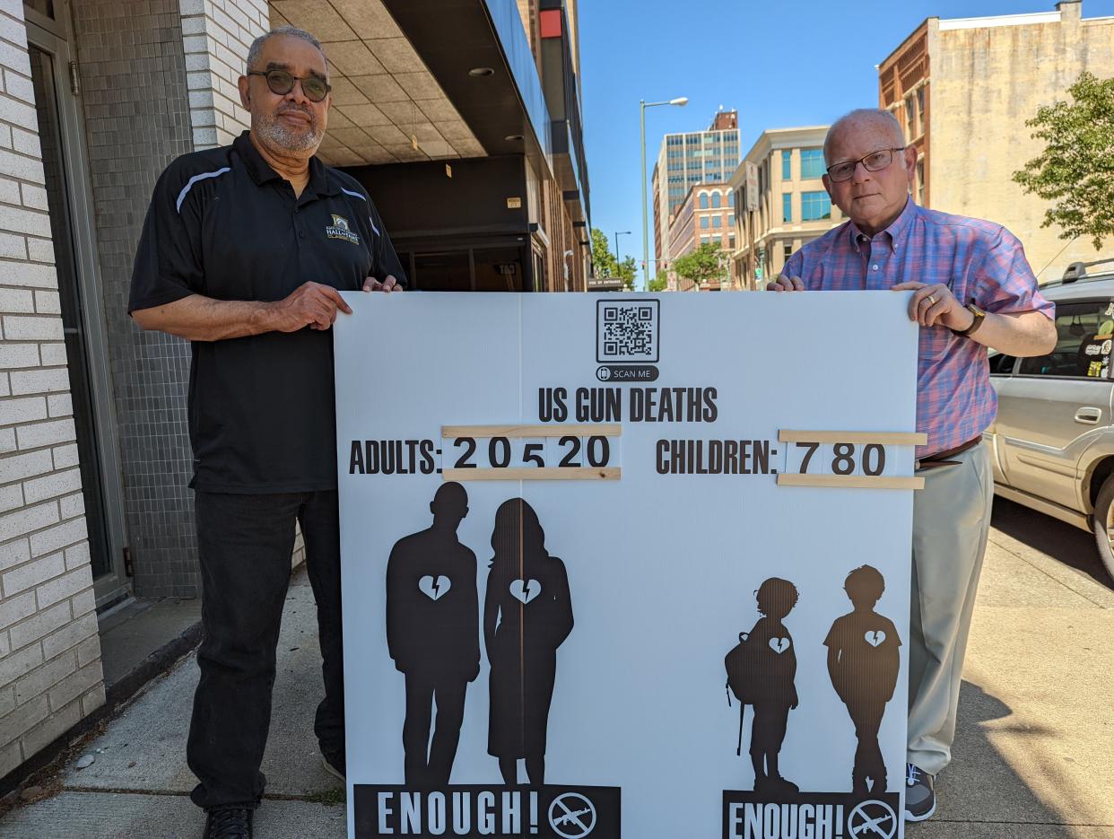 Longtime friends and civic leaders Ron Ponder, left, and Temple Israel Rabbi Emeritus John Spitzer stand with their latest joint project, "Do Not Stand Idle While Your Neighbor Bleeds," a sign campaign to raise awareness about the pervasiveness of gun violence in America.