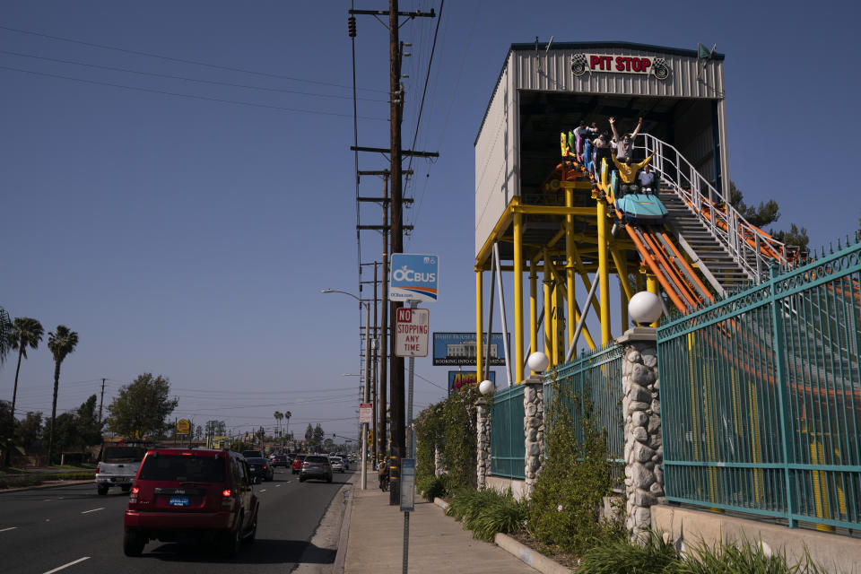 Visitors ride a roller coaster at Adventure City amusement park on the day of reopening in Anaheim, Calif., Friday, April 16, 2021. The family-run amusement park that had been shut since March last year because of the coronavirus pandemic reopened on April 16. (AP Photo/Jae C. Hong)