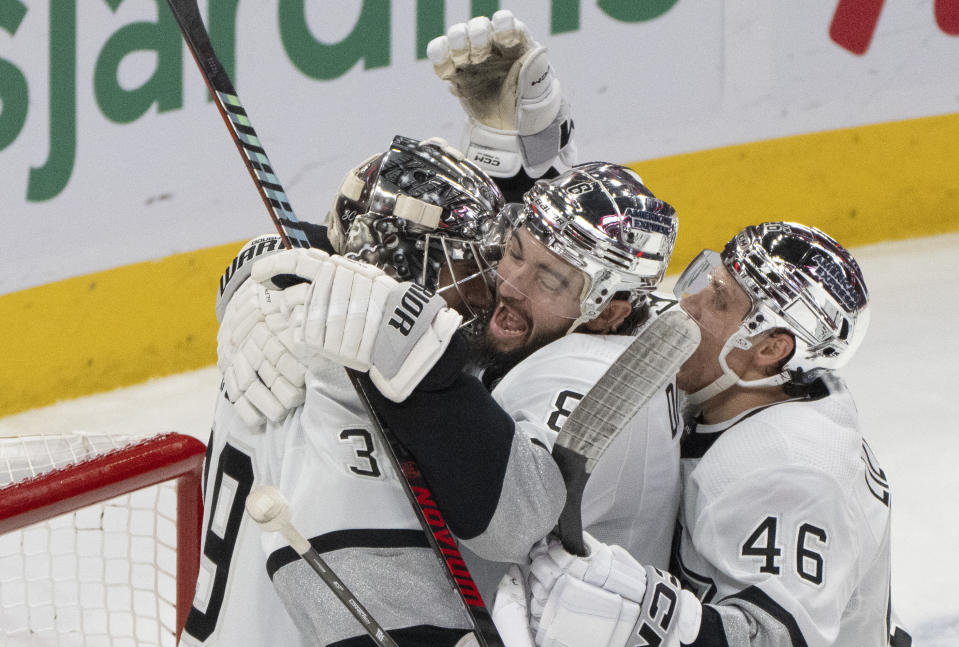 Los Angeles Kings goaltender Cam Talbot (39) is congratulated for the team's shutout win over the Montreal Canadiens by Drew Doughty (8) and Blake Lizotte (46), after an NHL hockey game Thursday, Dec. 7, 2023, in Montreal. (Christinne Muschi/The Canadian Press via AP)
