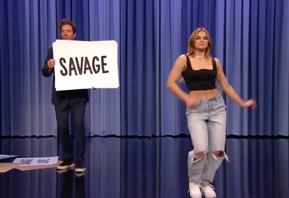 Jimmy onstage with Addison hold up a sign saying "Savage"