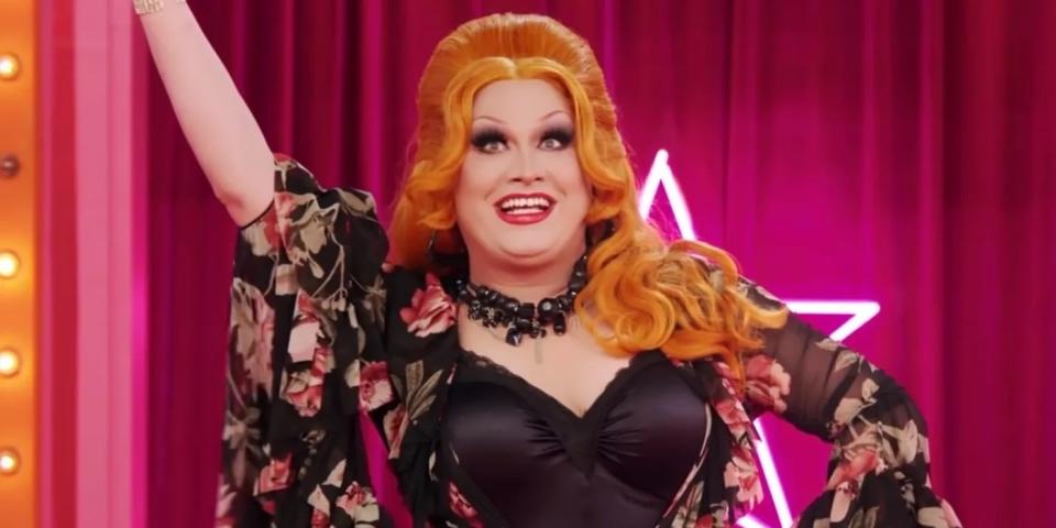 Jinkx smiling and raising her arm in the air