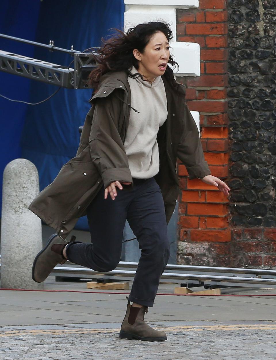 <p>Sanda Oh sprints down the street while filming a scene for <em>Killing Eve</em> on Sept. 8 in Kent, England. </p>