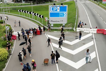 Anti-extradition bill protesters set up barriers outside the airport, in Hong Kong