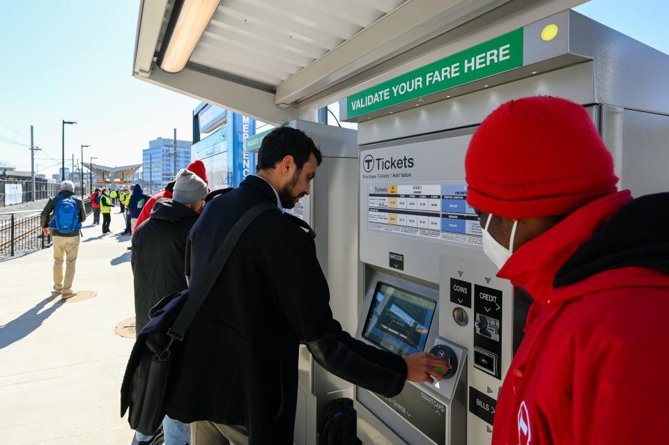A commuter pays for a ticket at the newly opened Union Square station in Somerville, part of the MBTA Green Line Extension, on Monday, March 21, 2022.