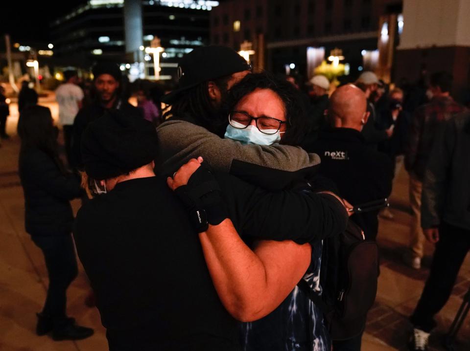 Three film industry workers comfort one another (AP)