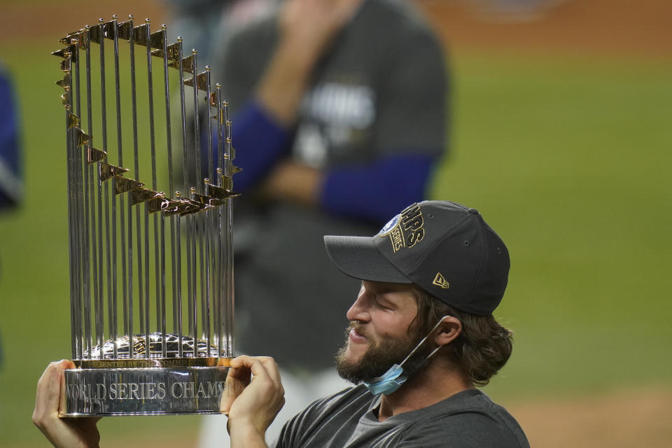 Los Angeles Dodgers pitcher Clayton Kershaw celebrates with the trophy after defeating the Tampa Bay Rays 3-1 to win the baseball World Series in Game 6 Tuesday, Oct. 27, 2020, in Arlington, Texas. (AP Photo/Eric Gay)