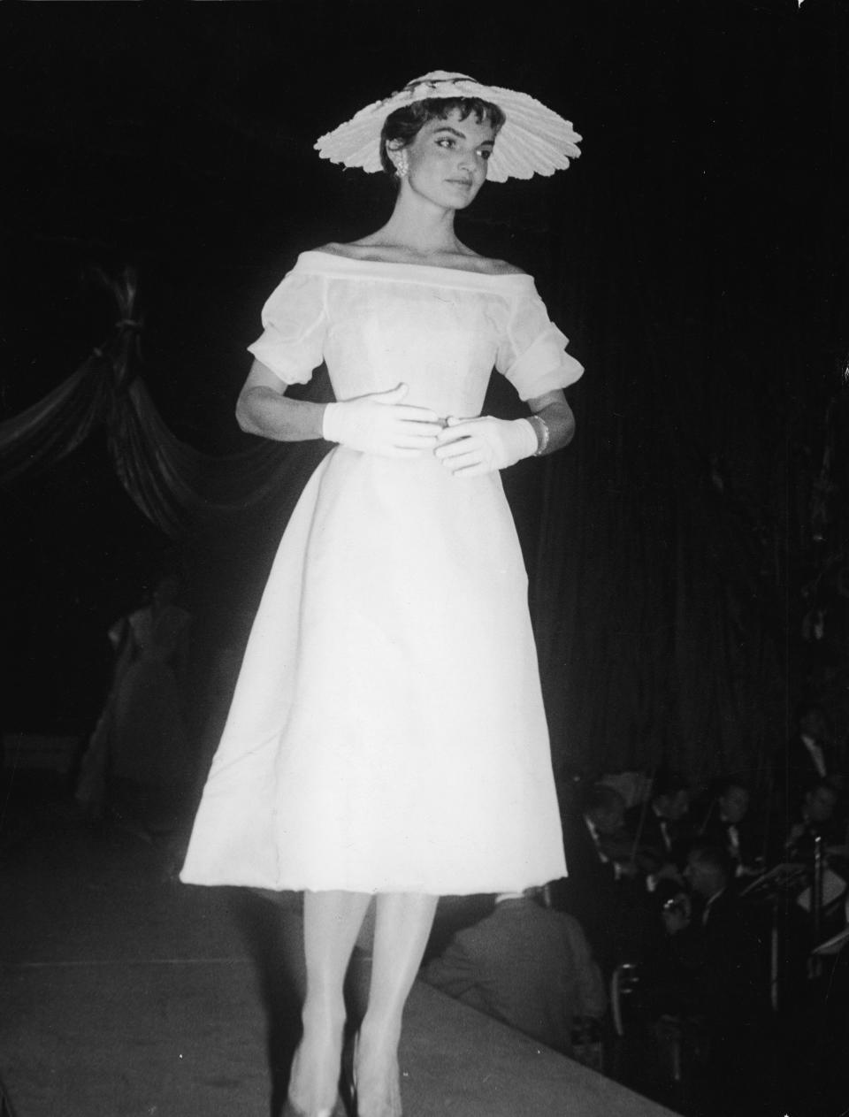 Kennedy walks the catwalk as she models a French designer dress, gloves and hat at the annual April in Paris ball at the Waldorf Astoria Hotel in New York City.