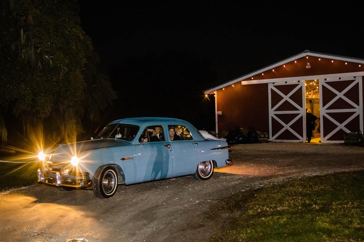 Sherri Anderson drives the newlyweds away in her 1951 Ford Deluxe, one of the first 2 cars purchased by Callan's Classics.