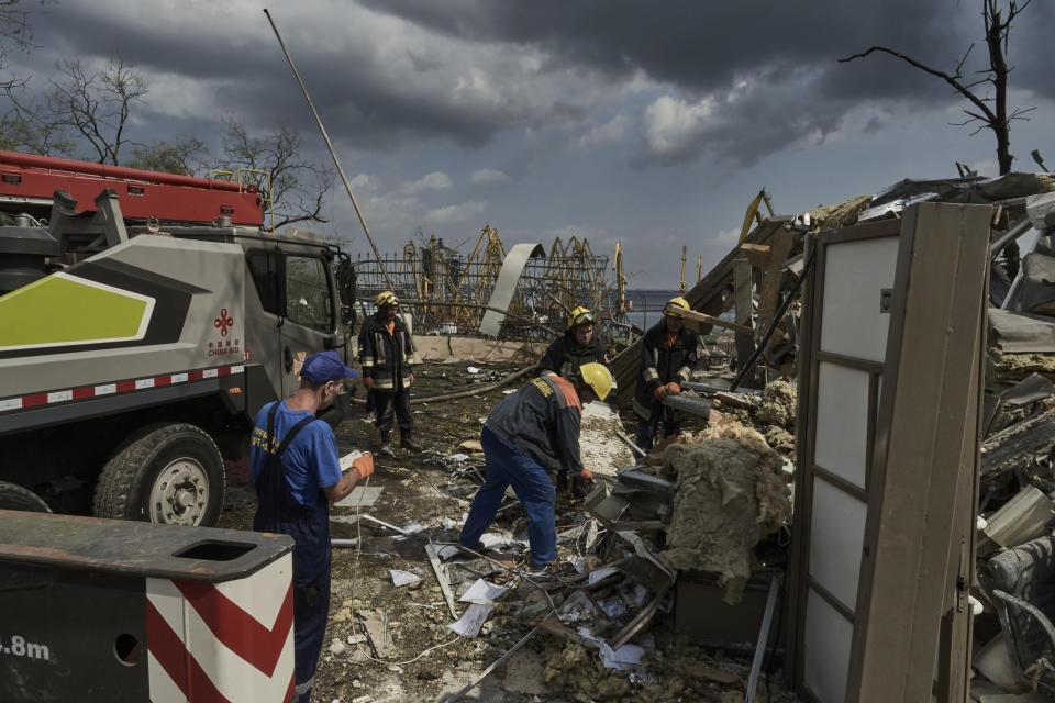 Emergency service personnel work at the site of a destroyed building near the Odesa Port after a Russian attack in Odesa, Ukraine, Thursday, July 20, 2023. Russia pounded Ukraine’s southern cities, including the port city of Odesa, with drones and missiles for a third consecutive night in a wave of strikes that has destroyed some of the country’s critical grain export infrastructure. (AP Photo/Libkos)
