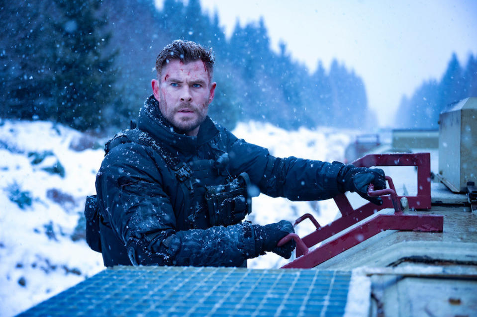 man with blood on his face outside in the snow