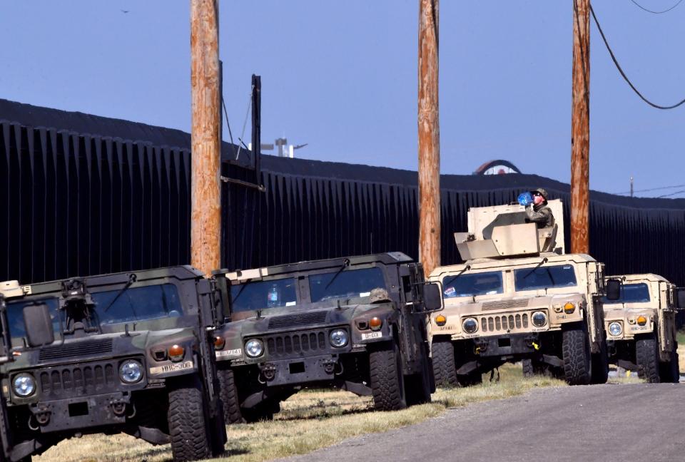 A National Guardsman drinks water while sitting atop his Humvee along the border fence near the Rio Grande River in Del Rio, Texas Monday Sept. 20, 2021. More than 10,000 National Guard members have been deployed to the border in Operation Lone Star. (Via OlyDrop)