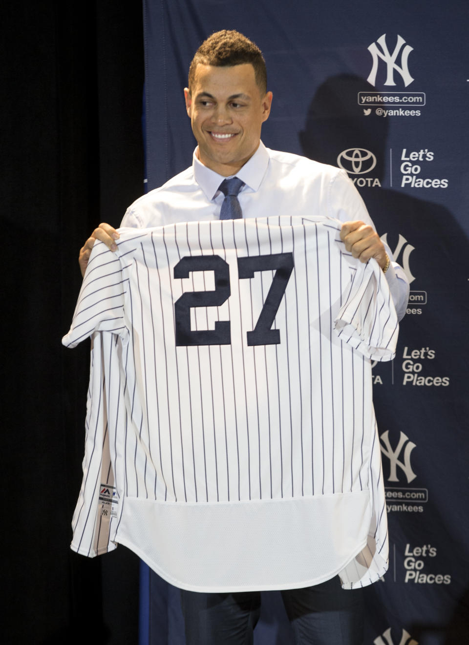 New Yankee Giancarlo Stanton shows off his new jersey during the Major League Baseball winter meetings in Orlando, Fla., Monday, Dec. 11, 2017. (AP Photo/Willie J. Allen Jr.)