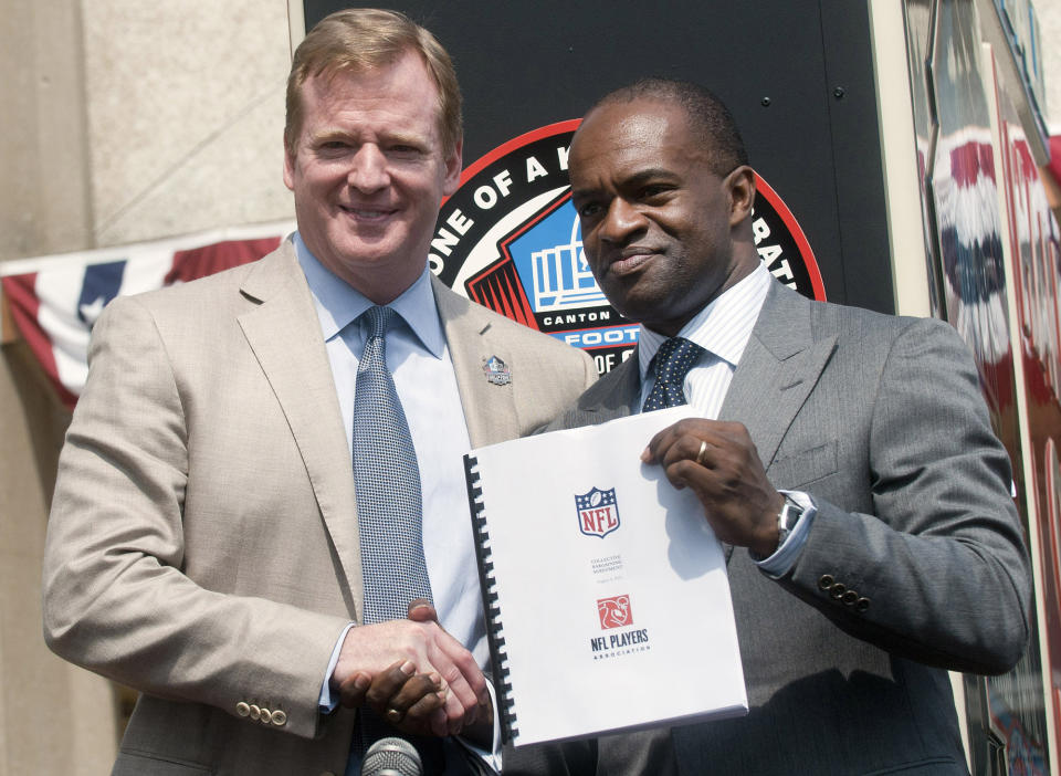 FILE - In this Aug. 5, 2011, file photo, NFL Comissioner Roger Goodell, left, and NFLPA Executive Director DeMaurice Smith shake hands after signing their collective bargaining agreement at the Pro Football Hall of Fame in Canton, Ohio. Ron Mix likes what he has seen and read regarding the new labor agreement between the NFL and its players from the deal struck last month that runs through the 2030 season. Mix, a Pro Football Hall of Famer, board member with the Pro Football Retired Players Association and retired attorney, praises NFL Commissioner Roger Goodell and NFLPA Executive Director DeMaurice Smith for their commitment to helping the retirees. (AP Photo/Phil Long, File)