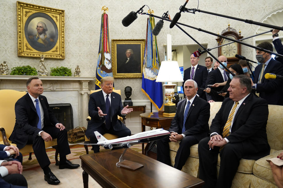 President Donald Trump meets with Polish President Andrzej Duda in the Oval Office of the White House, Wednesday, June 24, 2020, in Washington, as Vice President Mike Pence and Secretary of State Mike Pompeo listen. (AP Photo/Evan Vucci)