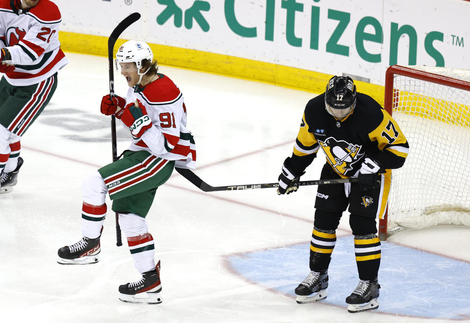 New Jersey Devils center Dawson Mercer (91) reacts in front of Pittsburgh Penguins right wing Bryan Rust (17) after scoring his third goal of the game during the third period of an NHL hockey game Tuesday, April 4, 2023, in Newark, N.J. The New Jersey Devils won 5-1. (AP Photo/Noah K. Murray)