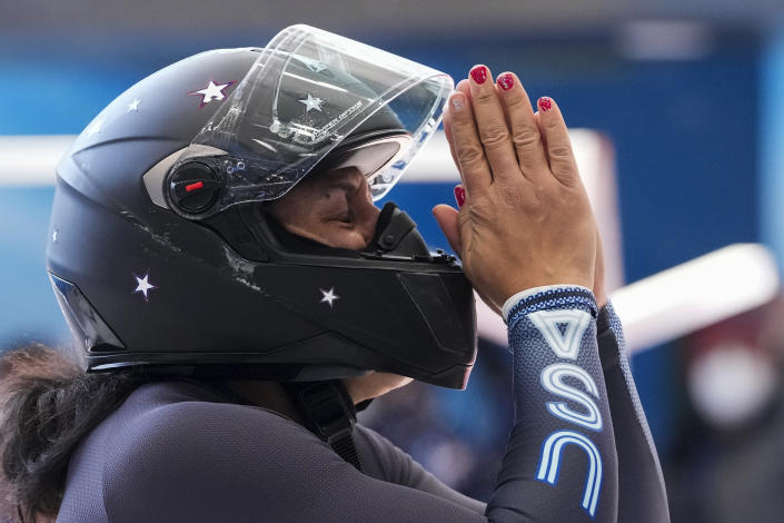 Elana Meyers Taylor, of the United States, celebrates after her women's monobob heat 4 at the 2022 Winter Olympics, Monday, Feb. 14, 2022, in the Yanqing district of Beijing. (AP Photo/Mark Schiefelbein)