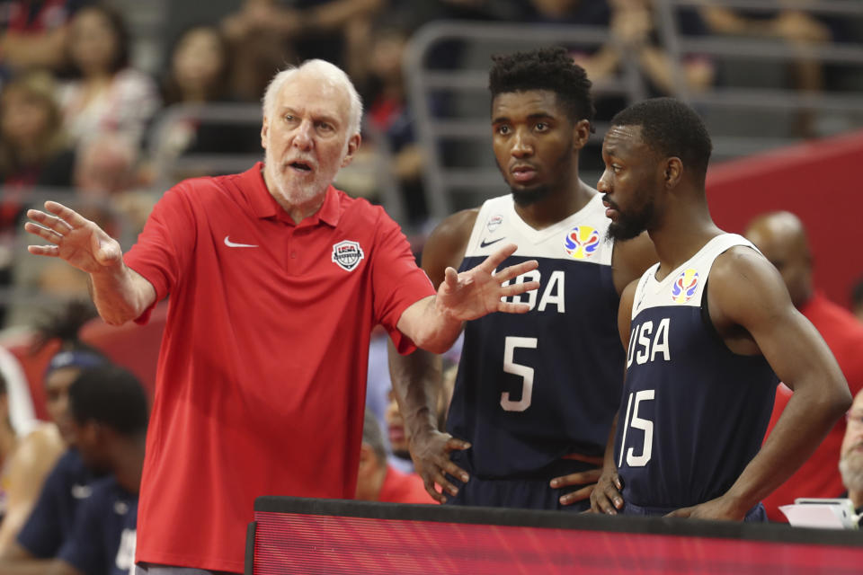 United States' coach Gregg Popovich, left talks to United States' Donovan Mitchell, center and United States' Kemba Walker at right for the FIBA Basketball World Cup in Dongguan in southern China's Guangdong province on Thursday, Sept. 12, 2019. The U.S. will leave the World Cup with its worst finish ever in a major international tournament, assured of finishing no better than seventh after falling to Serbia 94-89 in a consolation playoff game on Thursday night. (AP Photo/Ng Han Guan)