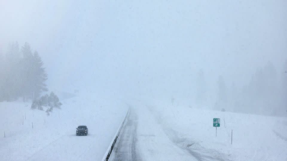 A vehicle drives on a section of Interstate 80 which remains closed in Truckee, California, on Sunday. - Mario Tama/Getty Images