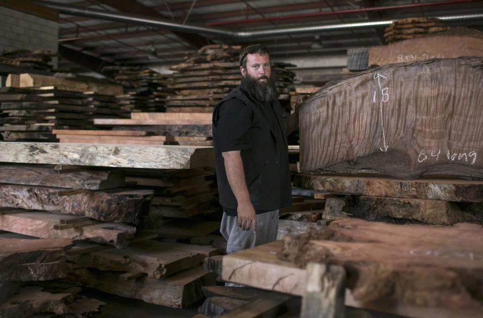 Landon Buck, owner of Redwood Burl Inc., looks on at the warehouse in Arcata, California