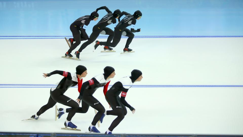 Sugar Todd of the U.S. (TOP) and Anastasia Bucsis of Canada compete in race two of the women's 500 meters speed skating event during the 2014 Sochi Winter Olympics, February 11, 2014. Picture taken using multiple exposure function. REUTERS/Laszlo Balogh