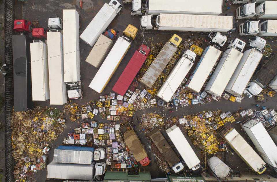 Spoiled fruit and vegetables are strewn across the CEAGESP flooded complex in Sao Paulo, Brazil, Tuesday, Feb. 11, 2020. Heavy rains brought Brazil's most populous city nearly to a halt on Monday with floods, mudslides and enormous traffic jams. Parts of the city received 100 mm (4 inches) of within three hours. (AP Photo/Andre Penner)