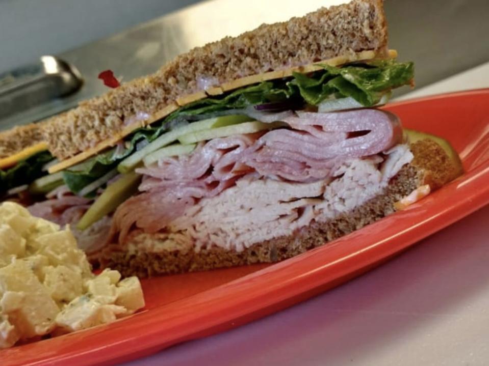 vermonter sandwich with turkey and ham on a red plate