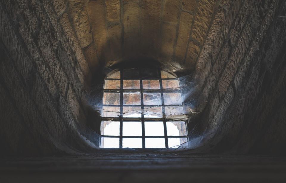 spooky urban legends   close up of window with cobwebs