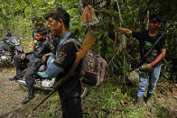 Tenetehara Indigenous men from the Ka’Azar, or Forest Owners, pause to talk about where they'll go next as they patrol their lands on the Alto Rio Guama reserve in Para state, near the city of Paragominas, Brazil, Tuesday, Sept. 8, 2020. Three Tenetehara Indigenous villages are patrolling to guard against illegal logging, gold mining, ranching, and farming as increasing encroachment and lax government enforcement during COVID-19 have forced the tribe to take matters into their own hands. (AP Photo/Eraldo Peres)