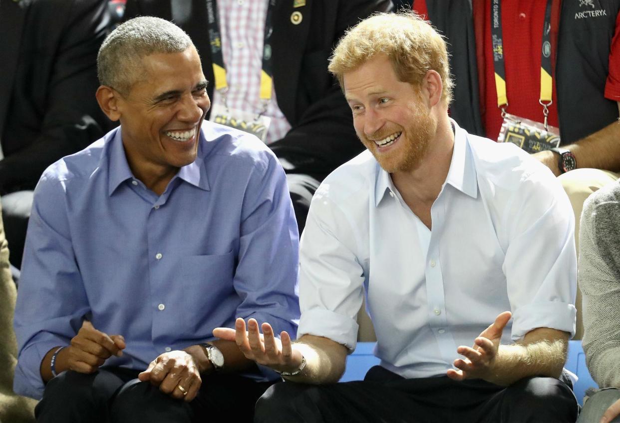 Former US President Barack Obama and Prince Harry share a joke as they watch wheelchair basketball on day 7 of the Invictus Games 2017 on September 29, 2017 in Toronto, Canada