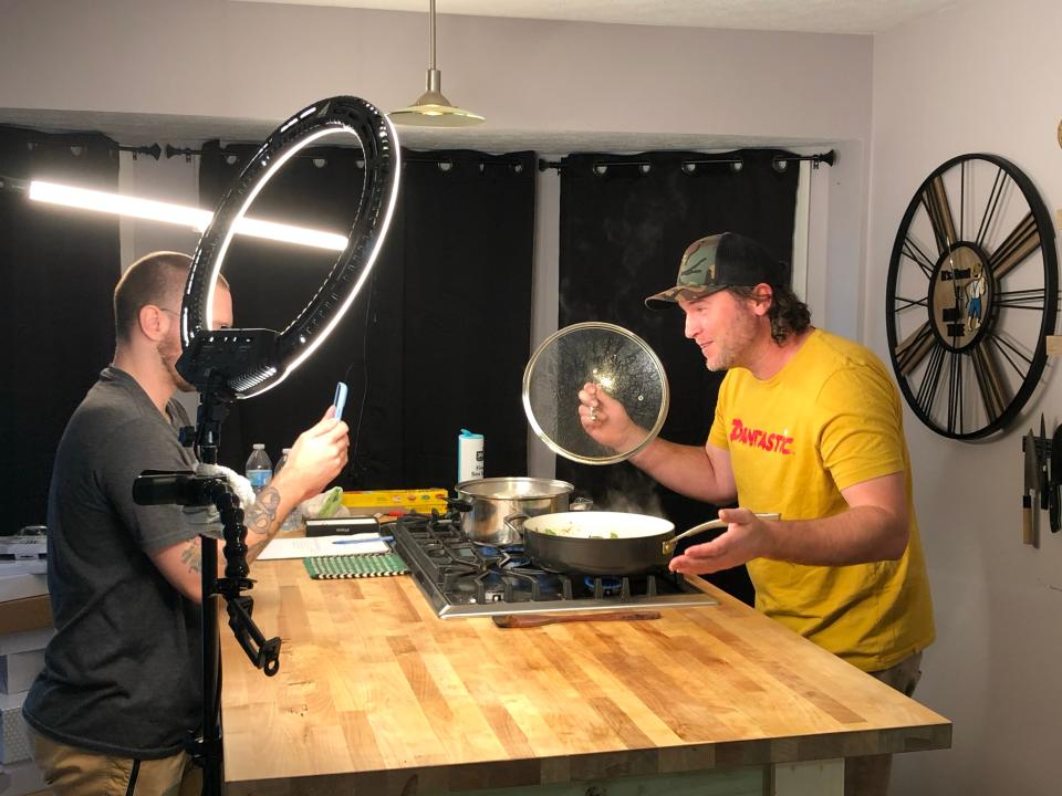 Dan Oliver, founder of Dan O's Seasonings making a Tik Tok video in his kitchen.