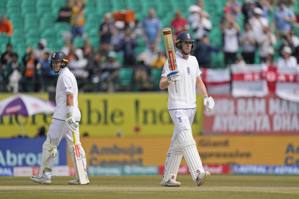 England's Zak Crawley celebrates his fifty runs as teammate Ollie Pope looks on on the first day of the fifth and final test match between England and India in Dharamshala, India, Thursday, March 7, 2024. (AP Photo/Ashwini Bhatia)