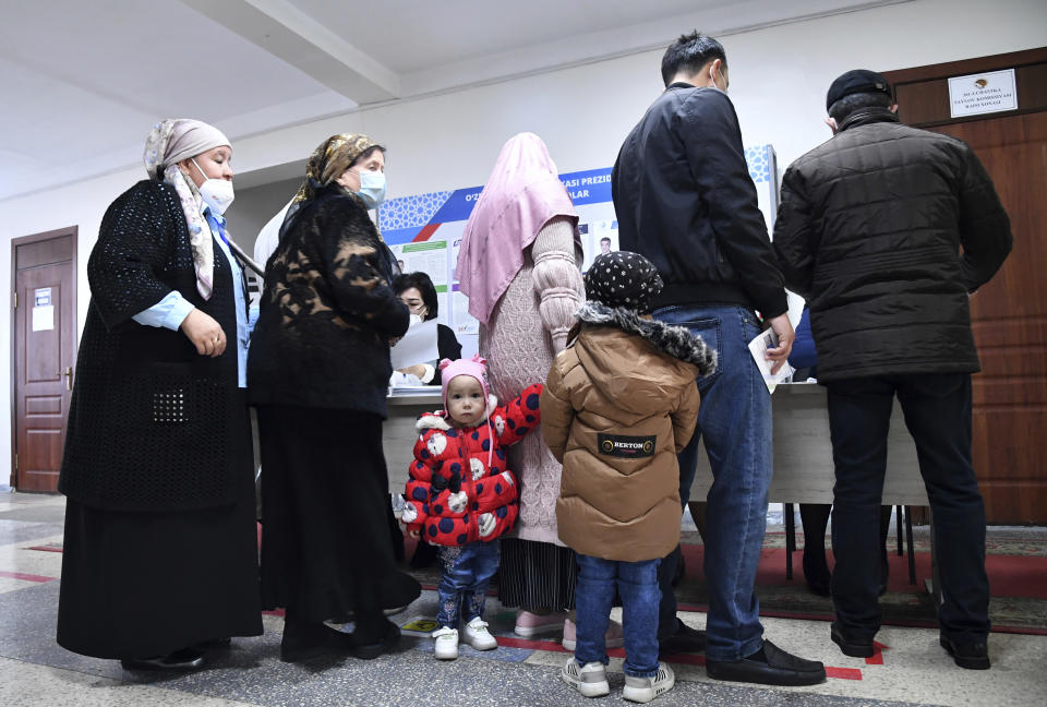 People line up to cast vote at a polling station during the presidential election in Tashkent, Uzbekistan, Sunday, Oct. 24, 2021. President Shavkat Mirziyoyev, who has relaxed many of the policies of his dictatorial predecessor but has made little effort at political reform, is expected to win a new term by a landslide against weak competition in an election Sunday.(AP Photo)