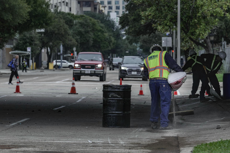 Workers clean the scene of a car accident on Saturday, Nov. 11, 2023, in downtown Houston, Texas. An early morning accident at the location left six people dead including former University of Houston and NFL football player D.J. Hayden. (Raquel Nataicchio/Houston Chronicle via AP)