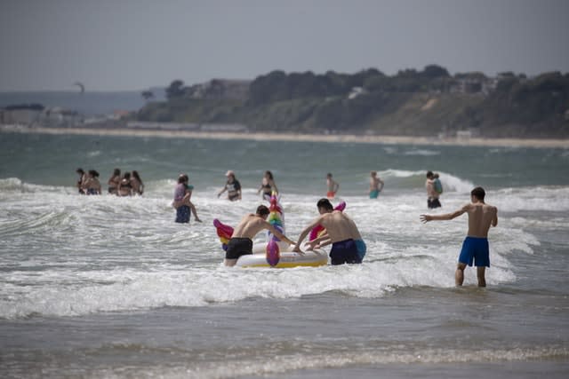 People enjoy the sunshine on the beach in Bournemouth, Dorset