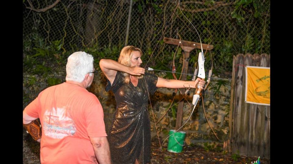 Christina Boomer Vazquez, GSTF Board Member, practices archery at the 2021 Campfires to Cocktails.