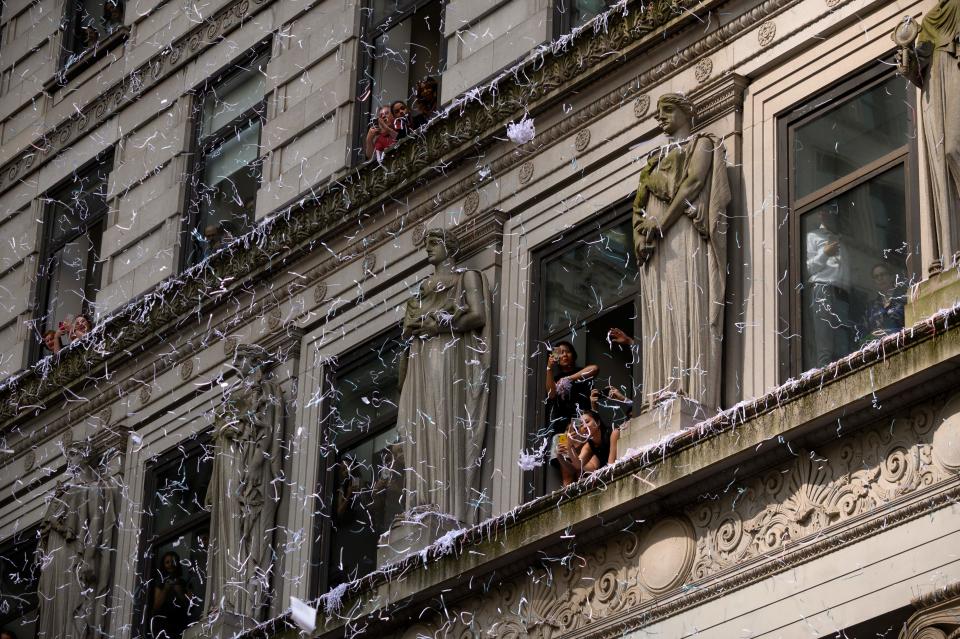 Fans cheer on members of the World Cup-winning US women's team as they take part in a ticker tape parade for the women's World Cup champions on July 10, 2019 in New York. - Tens of thousands of fans are poised to pack the streets of New York on Wednesday to salute the World Cup-winning US women's team in a ticker-tape parade. Four years after roaring fans lined the route of Lower Manhattan's fabled "Canyon of Heroes" to cheer the US women winning the 2015 World Cup, the Big Apple is poised for another raucous celebration. (Photo by Johannes Eisele/AFP/Getty Images)