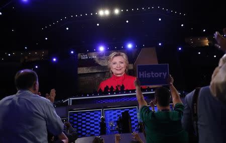 Democratic U.S. presidential nominee Hillary Clinton appears on a video monitor streamed live from New York at the Democratic National Convention in Philadelphia, Pennsylvania, U.S. July 26, 2016. REUTERS/Mark Kauzlarich