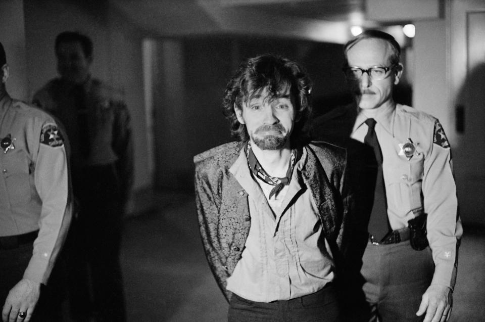 A scowling Charles Manson goes to lunch after an outbreak in court that resulted in his ejection, along with three women co-defendants, from the Tate murder trial, Dec. 21, 1970. The outburst started after Leslie Van Houten said she wanted to fire her new lawyer, a replacement for missing Ronald Hughes, and hire a woman attorney. Before she was ejected to an adjoining room with the others, Ms. Van Houten slapped a bailiff and told the judge 