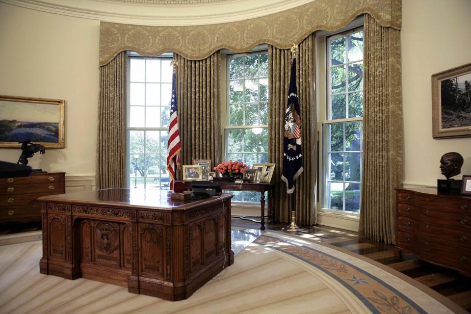 <p>President George W. Bush's desk is shown in an empty Oval Office.</p>