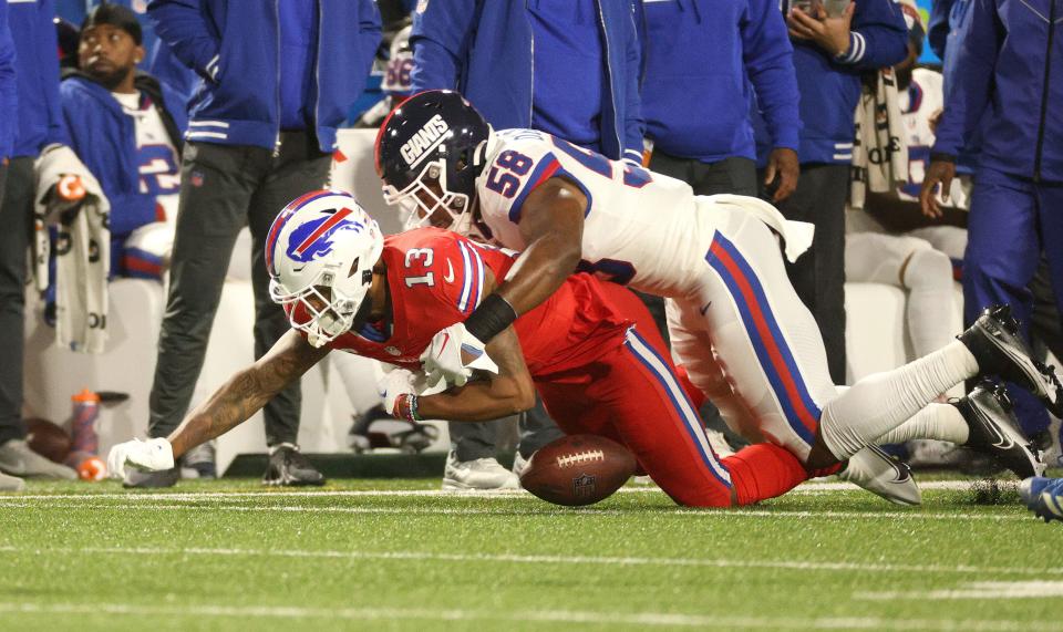 Buffalo Bills wide receiver Gabe Davis (13) fumbles the ball as he is tackled by New York Giants linebacker Bobby Okereke (58).