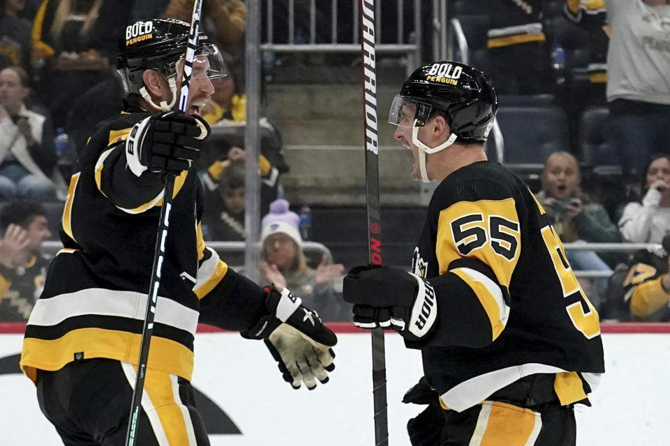 Pittsburgh Penguins' Noel Acciari (55) is congratulated by Jeff Carter, left, after scoring against the Vegas Golden Knights during the second period of an NHL hockey game, Sunday, Nov. 19, 2023, in Pittsburgh. (AP Photo/Matt Freed)