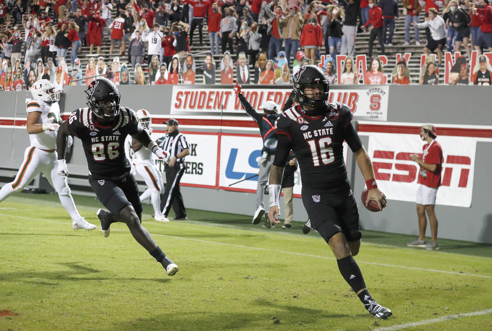 North Carolina State quarterback Bailey Hockman (16) celebrates after scoring on a 31-yard touchdown reception during the first half against Miami in an NCAA college football game Friday, Nov. 6, 2020, in Raleigh, N.C. (Ethan Hyman/The News & Observer via AP, Pool)